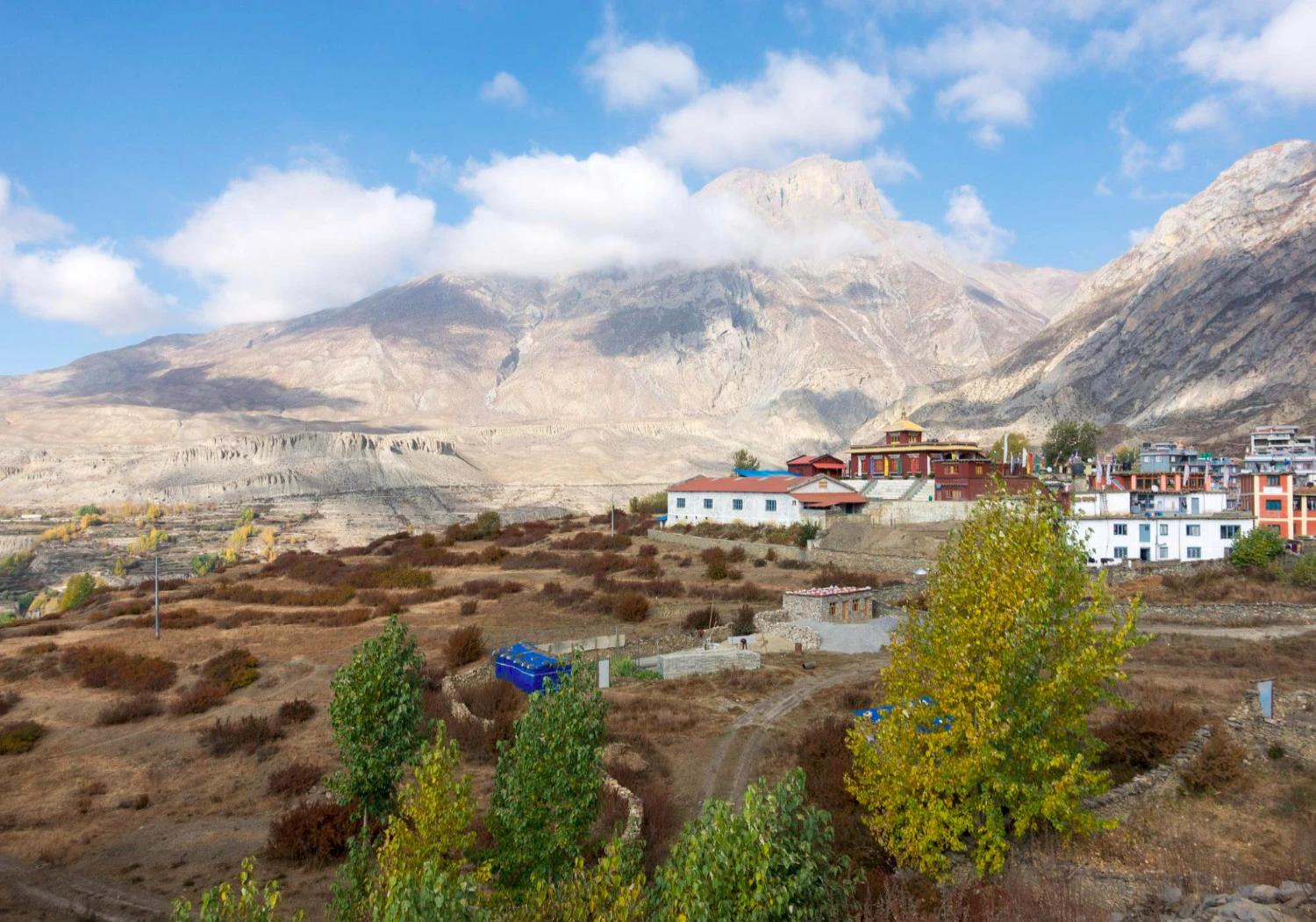 Scenic view of Muktinath village and monastery complex against rugged mountain peaks in Mustang Nepal